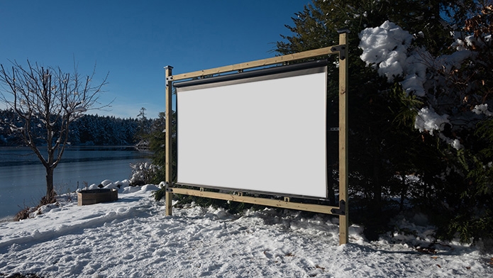 Manual pull-down outdoor projector screen setup on a Timberline Outdoor Movie Theater Screen Frame.